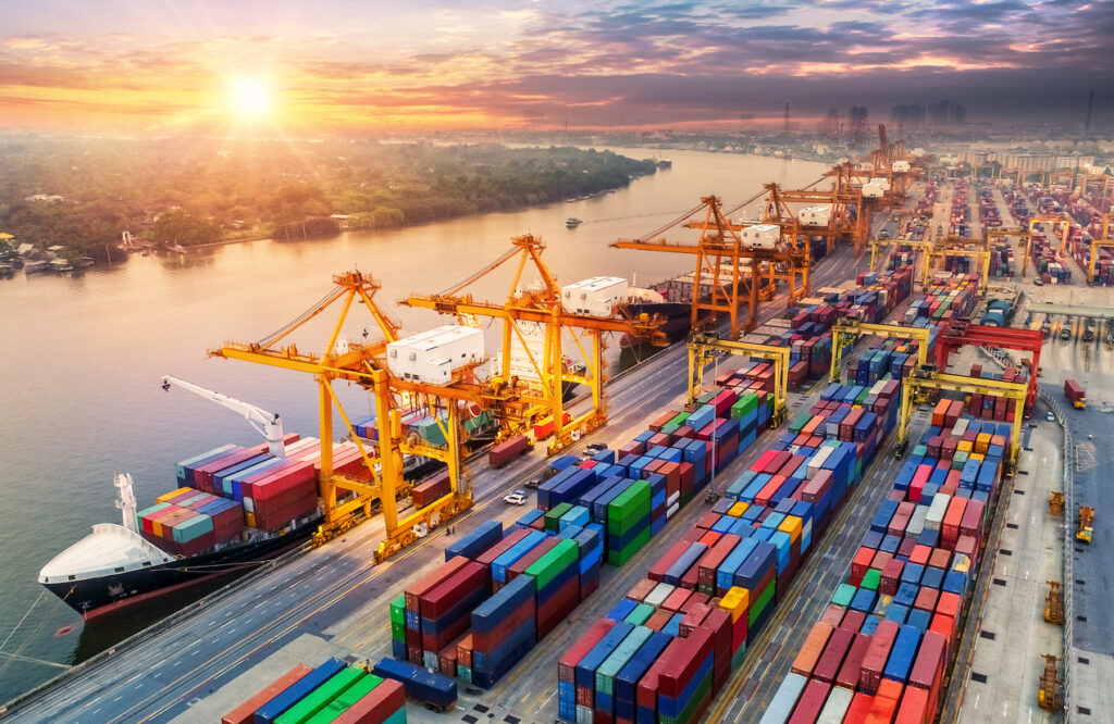 Cargo containers stacked at a busy sea port terminal